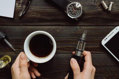 Vape ve kahve holding eller. Vaping hazır, izle, smartphone 