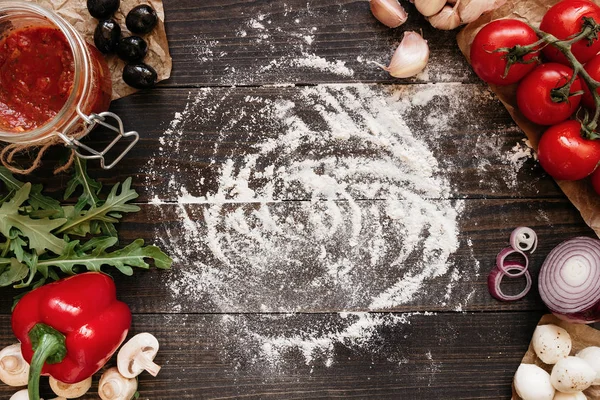Cooking Pizza. Pizza ingredients on the wooden table with copy space, top view