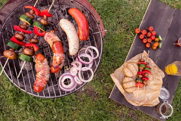 Grill with various delicious barbecue outdoor, top view — Stock Photo, Image