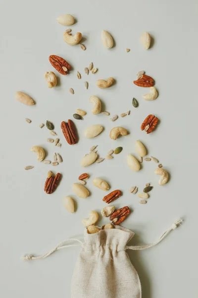 Nuts mix. Cashews, almonds and pecans on the gray background, top view — Stock Photo, Image