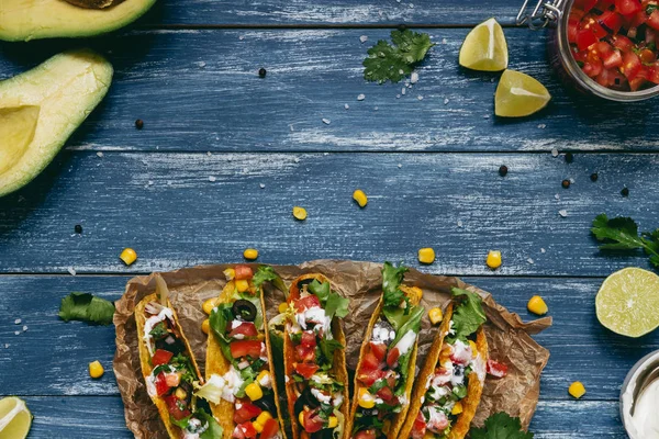 Mexican tacos with salsa and avocado on the wooden blue background, top view — Stock Photo, Image