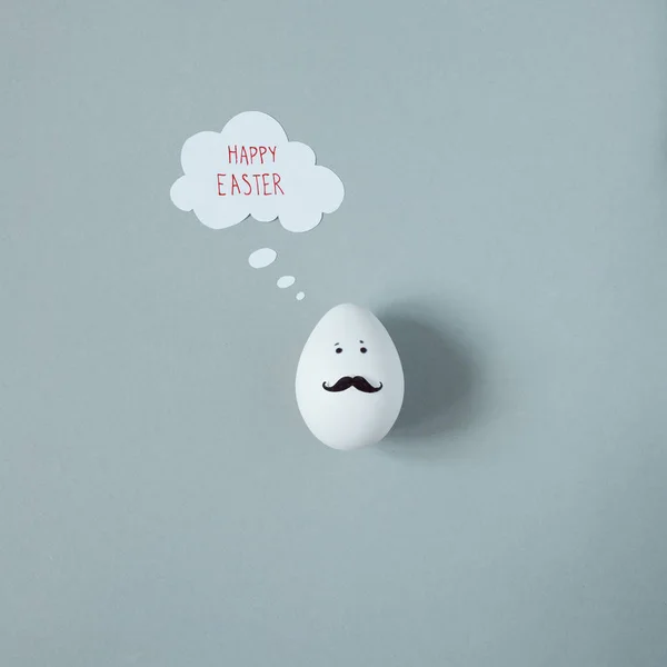 Happy Easter. Funny easter egg with mustache on gray background
