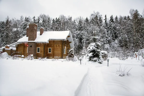 winter landscape, a country wooden house by the forest,