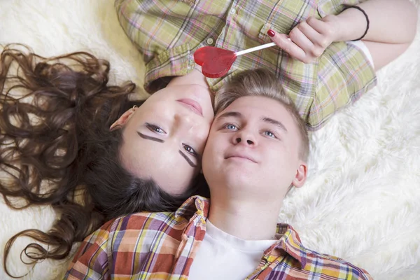 Young, loving couple, kiss each other, cover their lips with a c — Stock Photo, Image