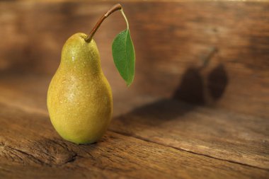 Close up image of ripe pear on wooden table 