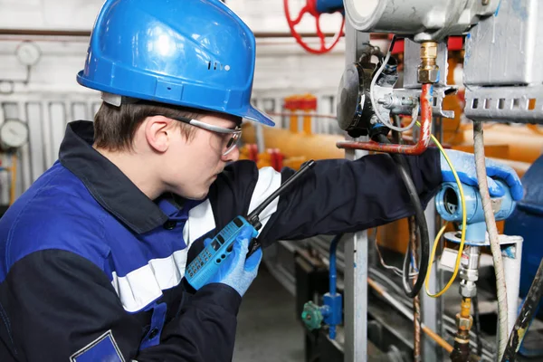 The mechanic - the repairman tightens bolts on a flanged connection of pipeline armature, operator production gas, locksmith repair instrumentation.