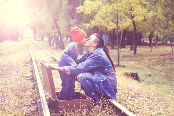 Love Concept Road Young Mother Kisses Her Son Sitting Railway — Stock Photo, Image