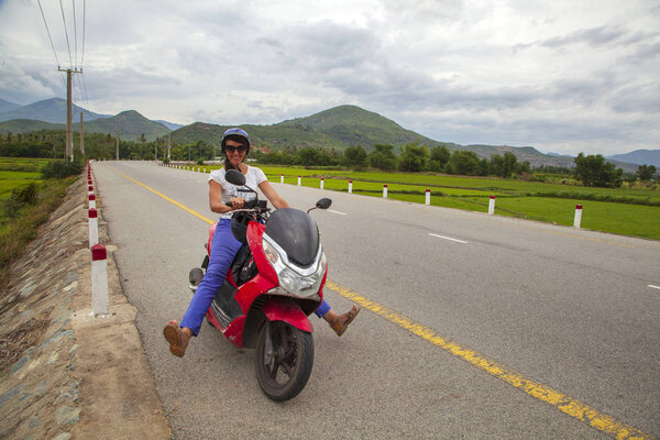 girl biker riding a scooter in the mountains of Vietnam, Woman i