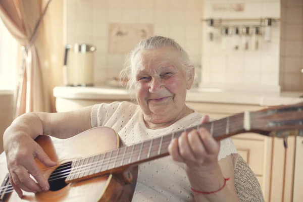Mature female hobbies, 90 year old grandmother plays guitar. Eld
