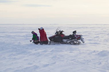  Far North, Yamal Peninsula, a snowmobile broke, a woman with a child walks along the snow tundra clipart