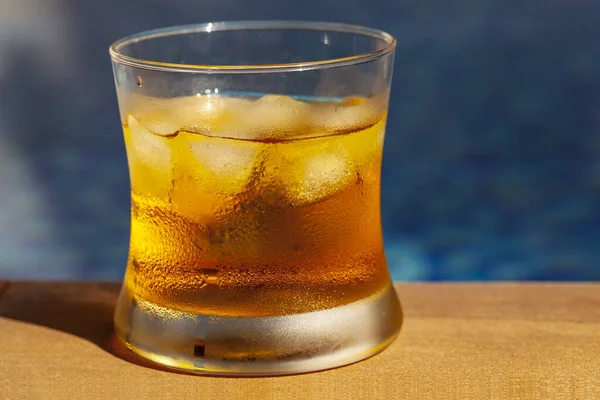 Chilled energy drink made from orange and pieces of ice