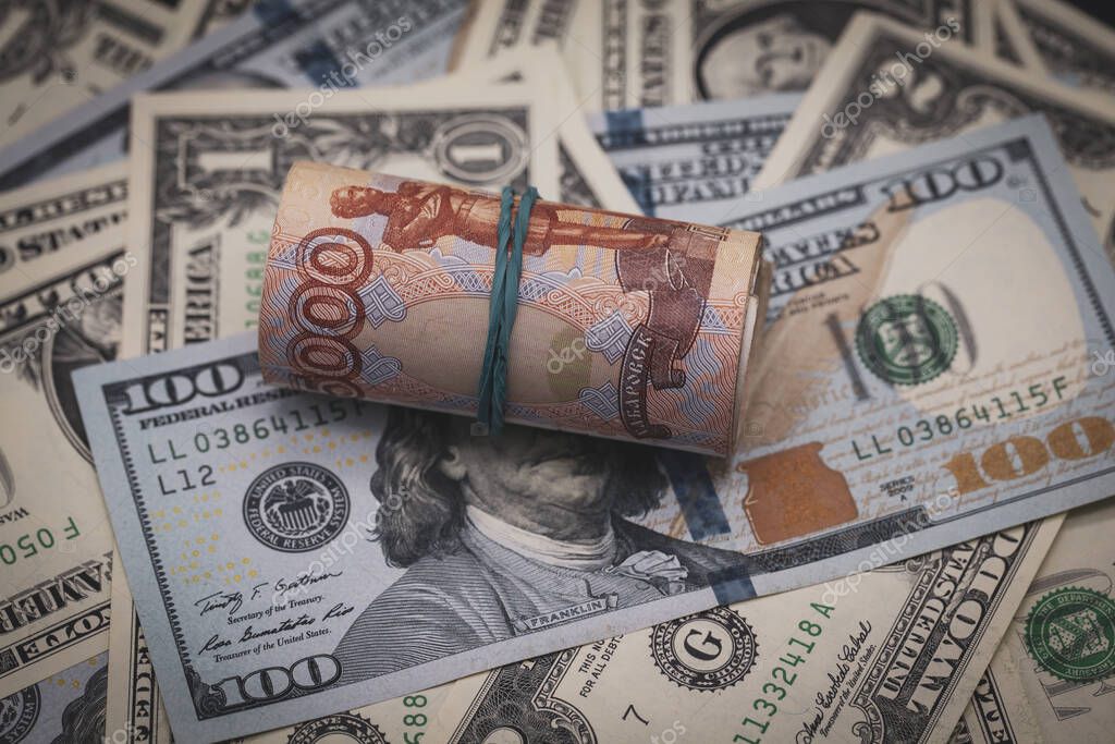 Financial concept, the volatility of the Russian economy, the dynamics of fluctuations of the ruble, a roll of five thousandth bills lie on dollars