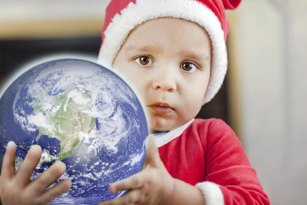 April 22, Earth Day, Concept - Save our planet, planet Earth in the hands of a little boy. Elements of this image were furnished by NASA.