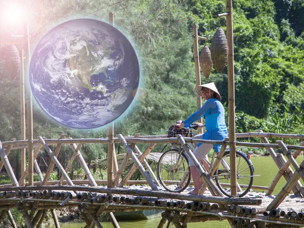 April 19, bicycle day, a girl on a bicycle travels in Vietnam, Elements of this image were furnished by NASA.