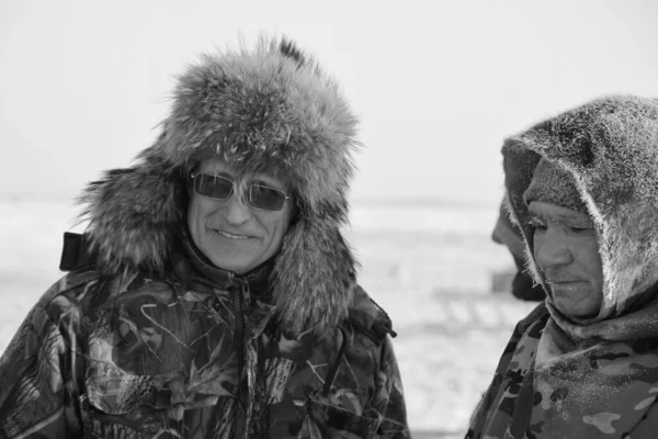 Tundra, Yamal Peninsula, far north, reindeer pasture, dwelling of northern peoples, assistant reindeer breeder,  the men  in national clothes, black and white foto