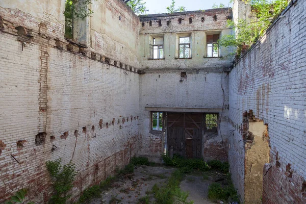 The ruins of an old brick building, ruined walls, Old wall of a ruined red brick house with empty Windows and no roof.