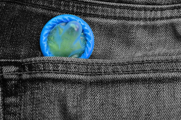 Condoms peeking out from jeans pocket. Stock Image