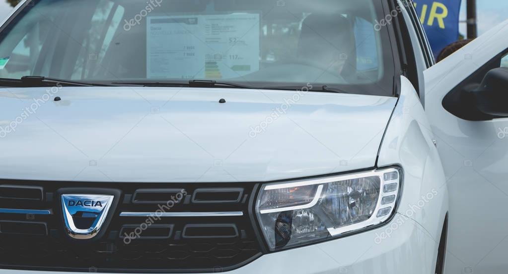 Sables d Olonne, France - May 07, 2017 : Dacia Tour 2017 is a commercial operation organized by the car builder in order to present its cars throughout France - A young man watching a car