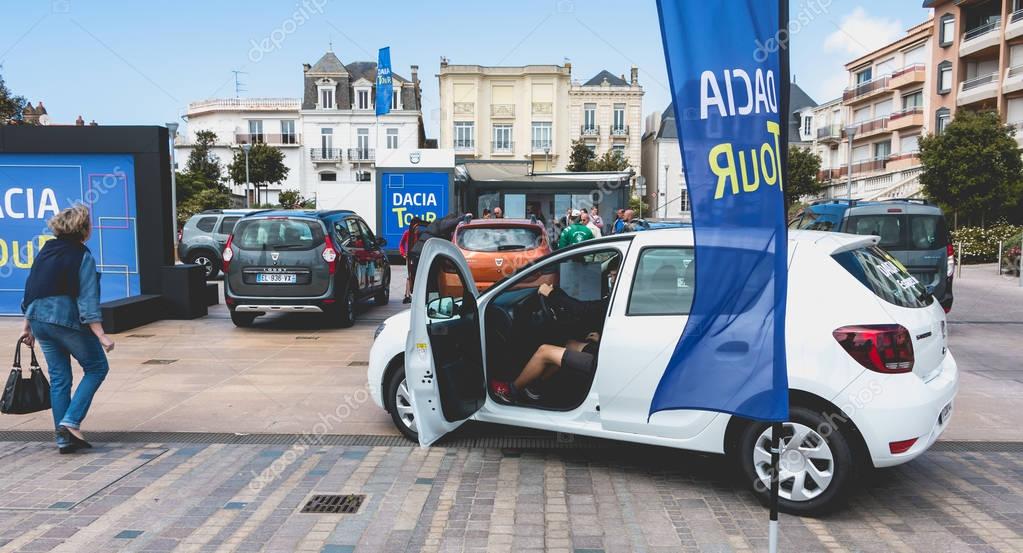 Sables d Olonne, France - May 07, 2017 : Dacia Tour 2017 is a commercial operation organized by the car builder in order to present its cars throughout France - A young man watching a car