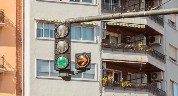 VALENCIA, SPAIN - June 18, 2017 : traffic light green with yellow arrow on right