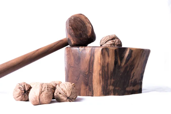 Wooden nutcracker with hammer and some nuts — Stock Photo, Image