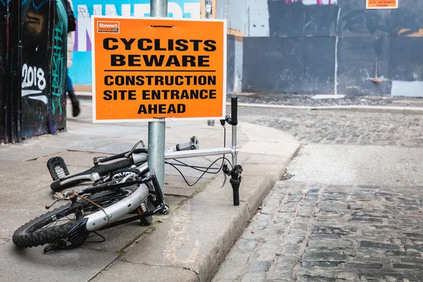 Cyclists Beware - Construction site entrance ahead - on a stree — Stock Photo, Image