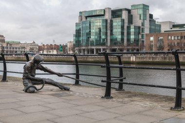 Dublin, Ireland - February 11, 2019: Statue by Dony MacManus of The Linesman on city quay on a winter day