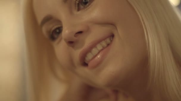 Young blonde girl smiles broadly — Stock Video