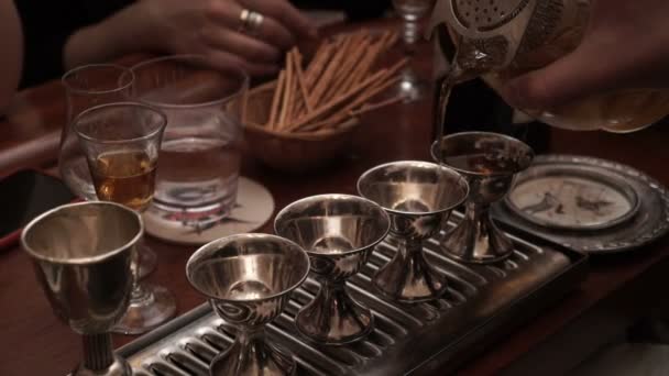 Barman spills a drink in metal glasses — Stock Video