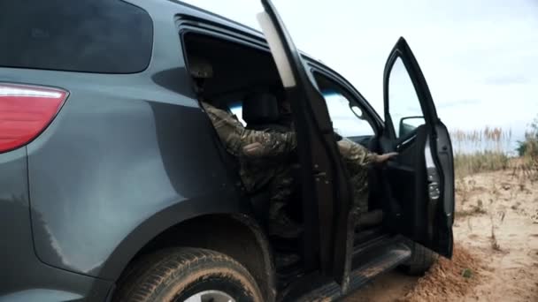 Military soldiers with weapons run out car. Soldiers in military gear and weapon — Stock Video