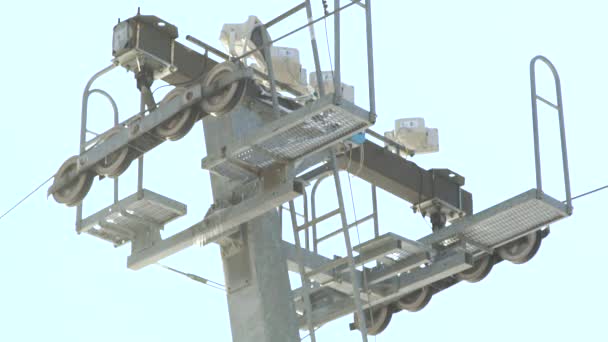 Ski elevator on snow mountain at ski winter resort close up. Ski lift on ropeway for for skiers and snowboarders on snow slope. — Stock Video