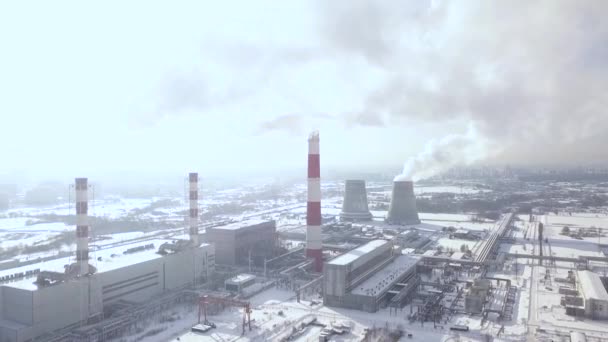 Smoking chimney at industrial plant. Aerial industrial landscape boiler pipe and smoke. Drone view smoking pipes with smoke in industrial area on winter landscape. — Stock Video