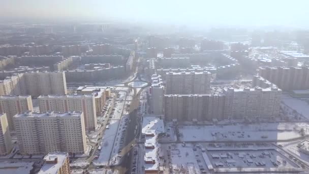 High rise residential buildings in winter city aerial view. City infrastructure in modern town drone view. Architecture and moving car on city street. — Stock Video