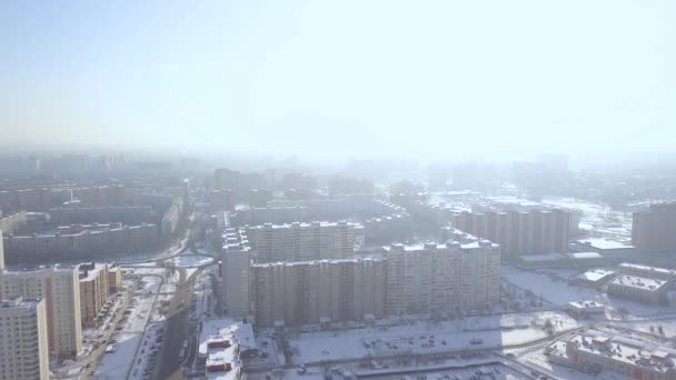 Modern residential buildings in winter city drone view. City infrastructure in modern town and road for car traffic aerial view. — Stock Video
