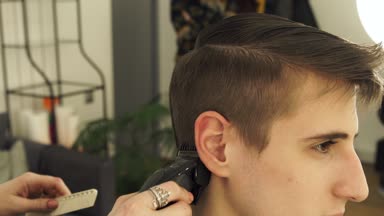 Hairdresser Making Haircut With Electric Razor Haircutter