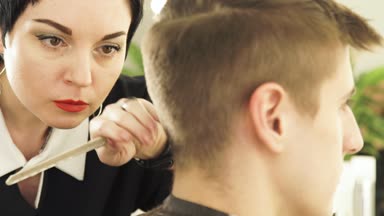 Kuaför kesim erkek saç güzellik okulda Elektrikli tıraş makinesi ile. Erkek saç kesimi saç kesme makinesi ile berber içinde yapma kadın haircutter yakın çekim.