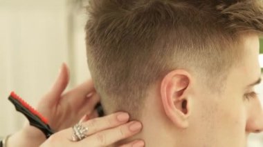 Güzellik salonunda çalışan saç stilisti kapatın. Kuaför saç stili kesmek sonra bitir. Kuaför Salonu içinde erkek saç modeli.