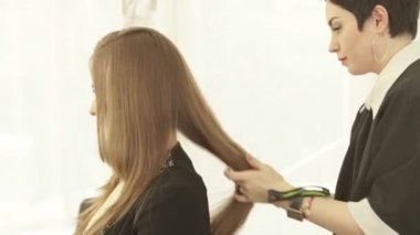 Kuaförü Kuaför Güzellik Studio sonra uzun saçlar için saç modeli yapmak. Haircutter yakından bitirmek kuaförlük salonda kadın saç modeli.