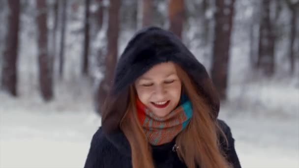 Beautiful girl smiling flirting and playing snowballs — Stockvideo
