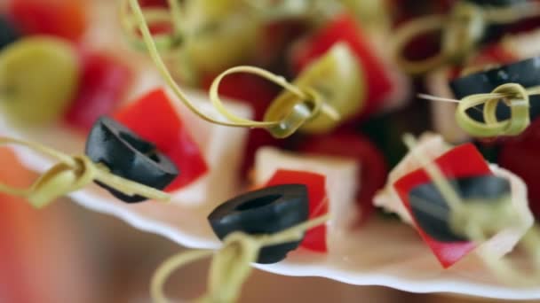 Small canape with olives, cheese, cherry tomatoes and cucumber close-up — Αρχείο Βίντεο