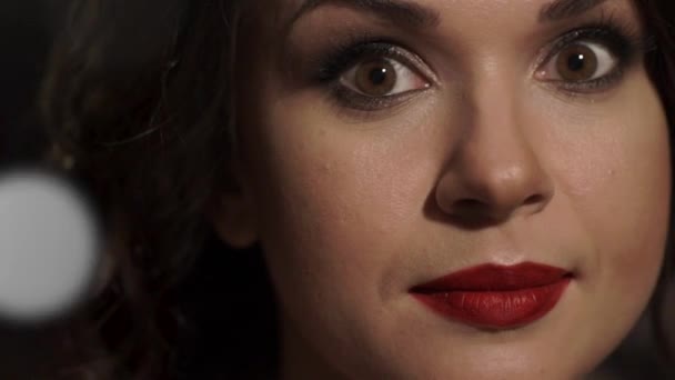 Fantastisk vacker kvinna med röda läppar höjer huvudet, öppnar bruna ögon tittar på kameran. — Stockvideo