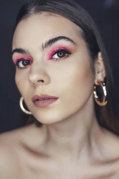 Beautiful woman with pink makeup portrait