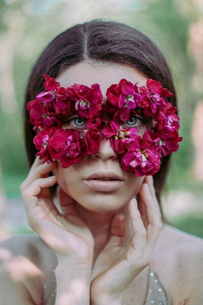 Beautiful woman with flower mask beauty
