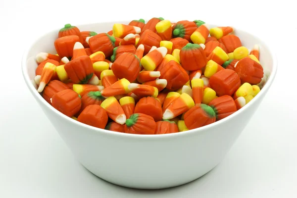 Bowl of candy corn and pumpkins isolated — Stock Photo, Image