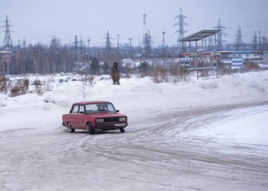 Russia, Novosibirsk - November 30, 2019. Russian old low red car 