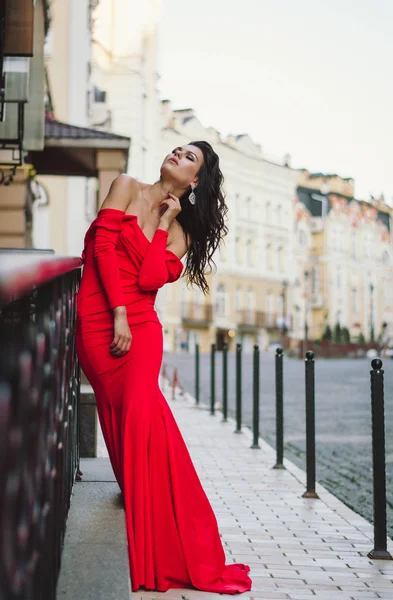 Şehvetli şık esmer sokakta uzun Kırmızı elbiseli. Moda fotoğraf.