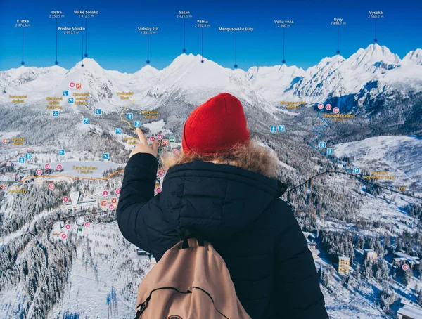 Strbske Pleso, Slovakia - December 2019: woman studying a map of High Tatra mountains — 스톡 사진