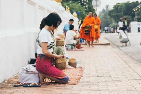 Luang Prabang, Laos - Mai 2019 : Une femme laotienne fait des offrandes aux moines bouddhistes lors d'une cérémonie d'aumône — Photo