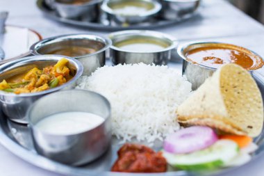 Close up on Indian dal bhat served with steamed rice and lentil soup clipart