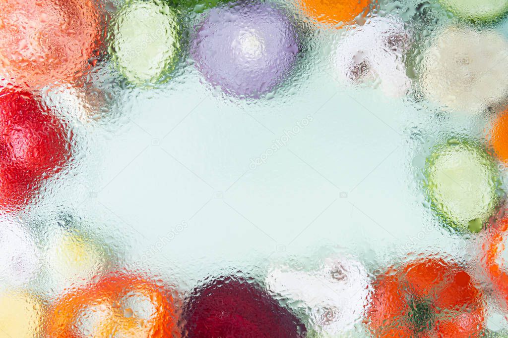 Assorted sliced vegetables on green background. Soft focus, water drops texture